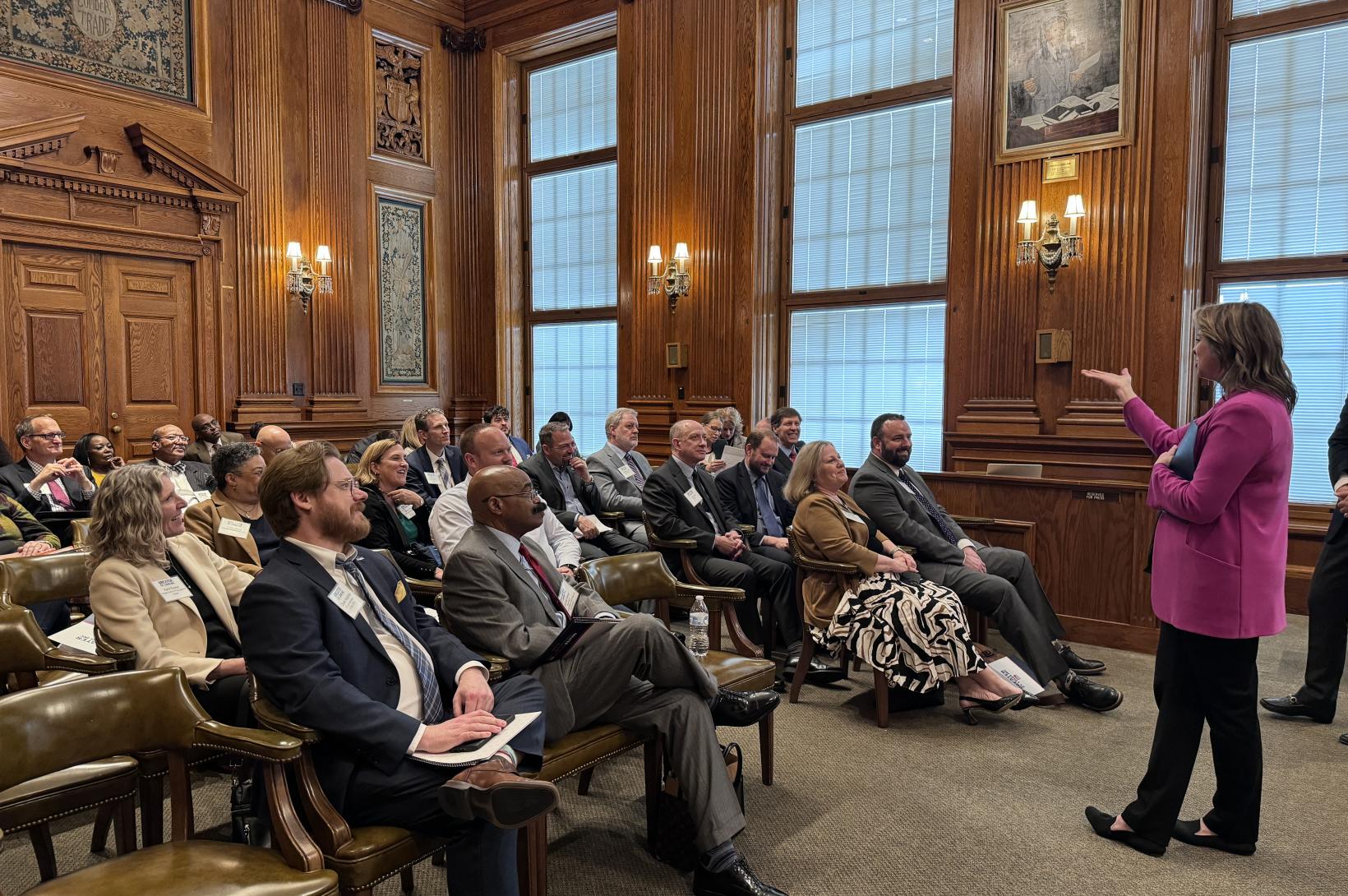 A Missouri legislator talks to a group of seated guests at the Missouri Capitol.